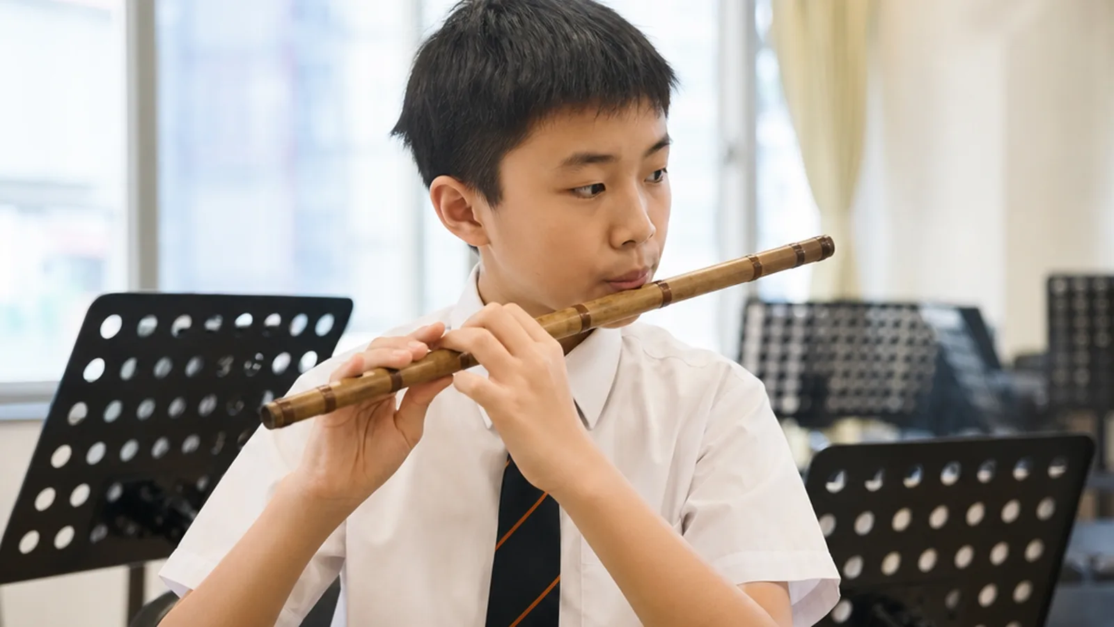 Mudi (Shepherd's Flute): Complete Overview, History and Learning Guide 5 A student learning to play a wooden wind instrument